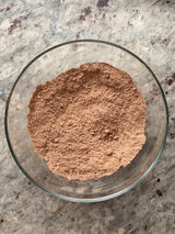 Glass bowl filled with brown powder on a speckled countertop – thumbnail 4