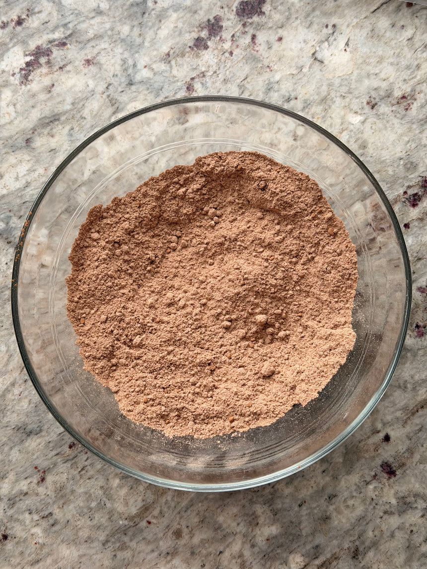 Glass bowl filled with brown powder on a speckled countertop – photo 4