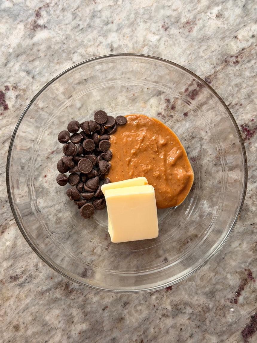 Glass bowl with chocolate chips, peanut butter, and butter on a marble surface – photo 5