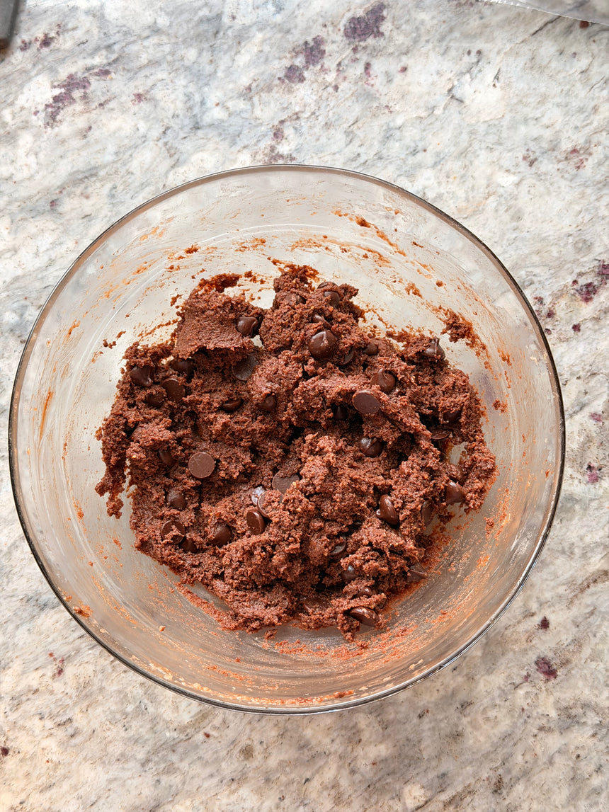 Chocolate cookie dough with chocolate chips in a glass bowl on a marble countertop – photo 10