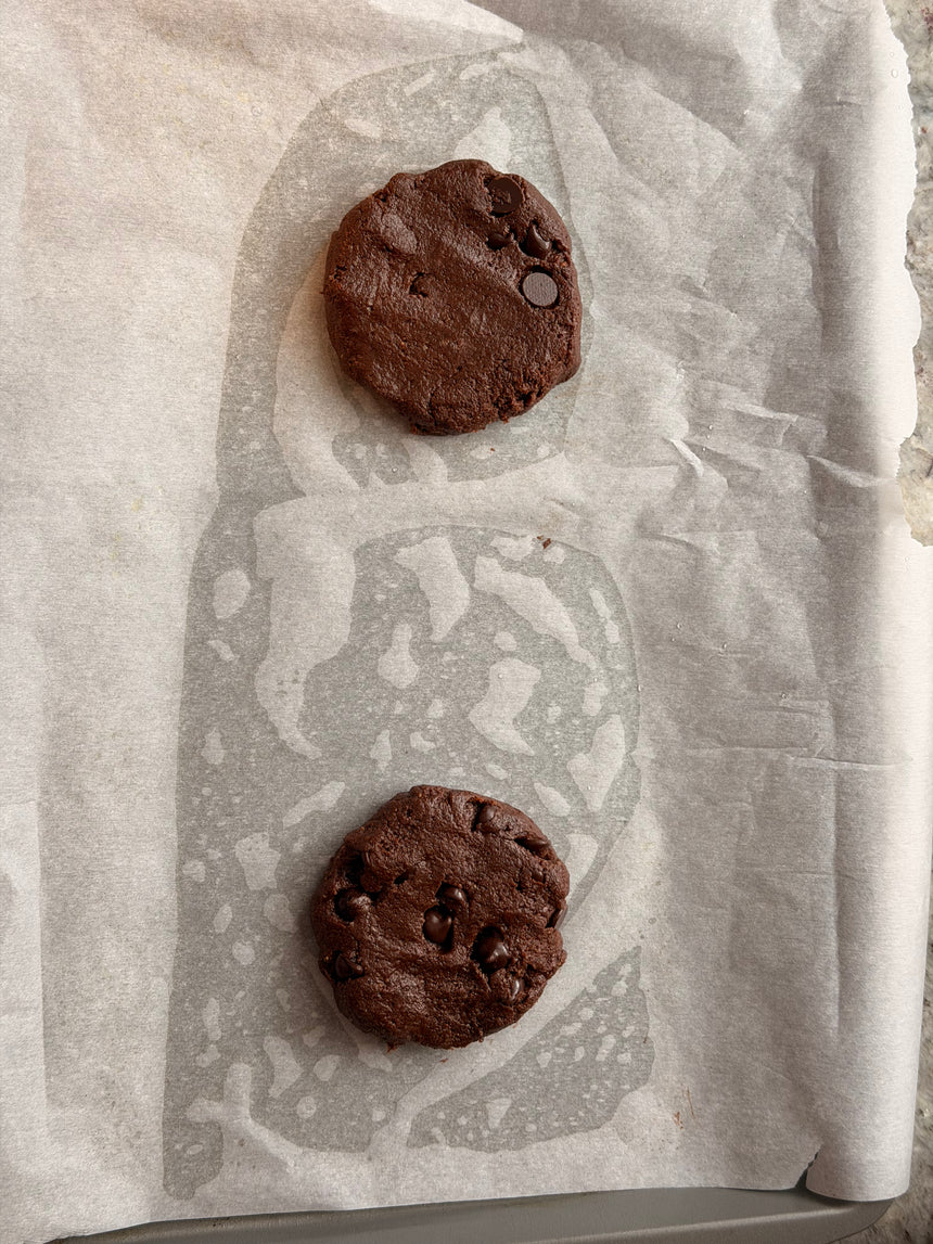 Two chocolate cookies on a piece of wax paper. – photo 11