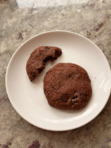 Two chocolate cookies on a white plate with a marble countertop background – thumbnail 12
