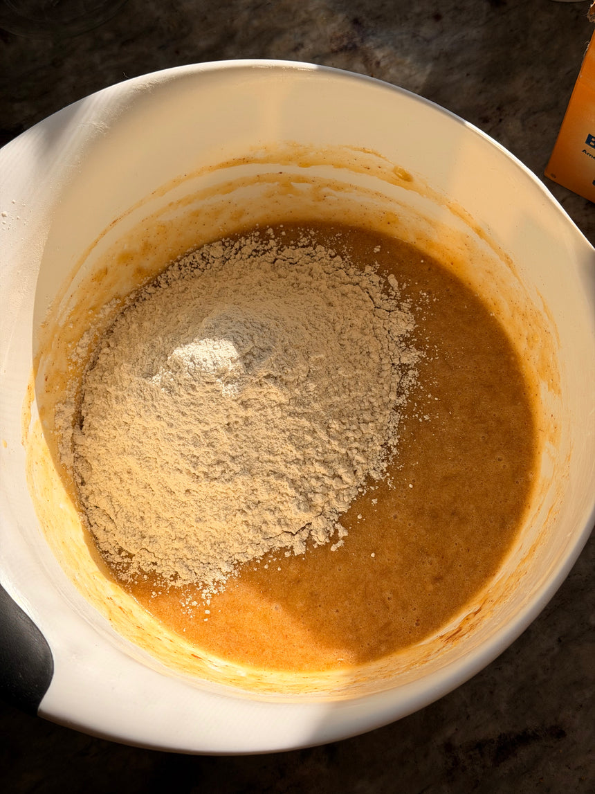 Dry ingredients being mixed with a liquid in a white bowl. – photo 7