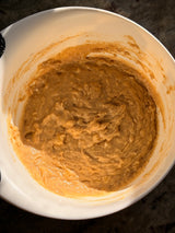 Brown batter in a white mixing bowl on a dark surface – thumbnail 8