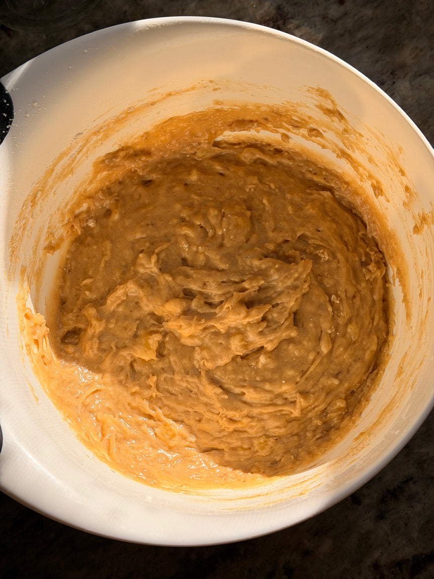 Brown batter in a white mixing bowl on a dark surface – photo 8