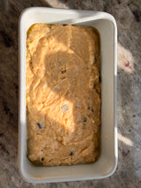 Unbaked cake batter with chocolate chips in a loaf pan on a marble surface – thumbnail 10